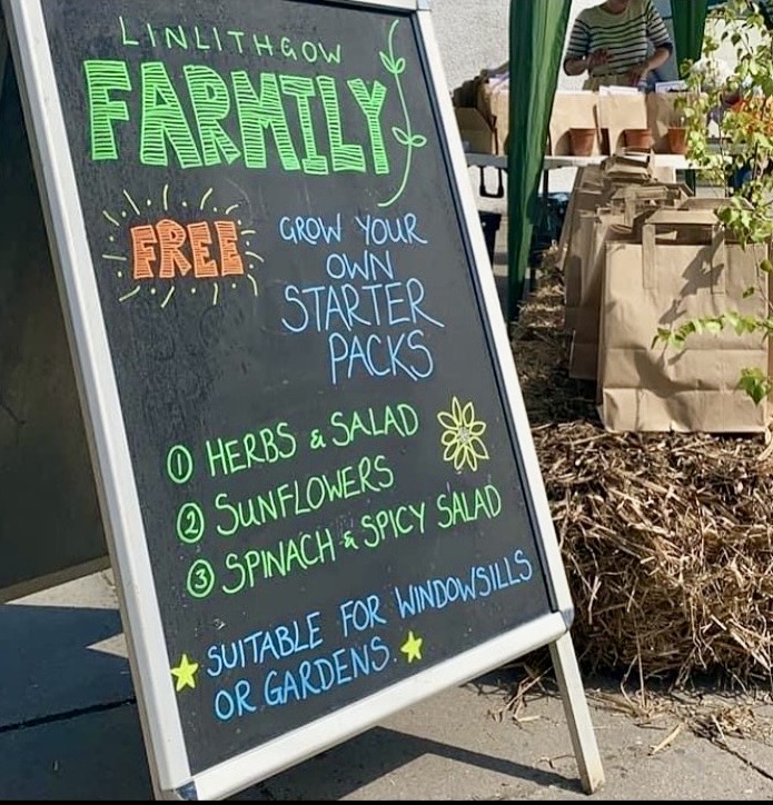 A frame 'Linlithgow Farmily. Free starter kits' beside stall